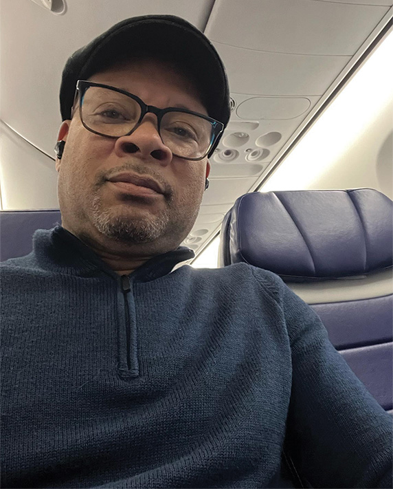 A selfie of Nevada Attorney General Aaron Ford on a plane, wearing a hat